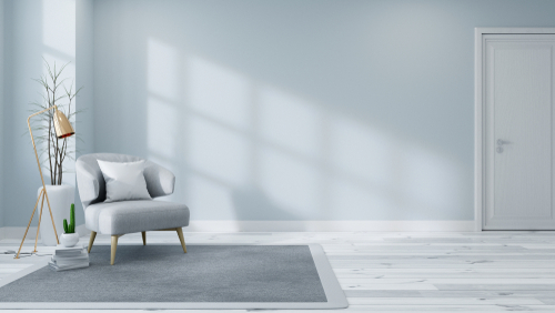 powder blue walls, gray sisal carpet and minimalist living room furniture