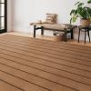 Caspian Performance Luxury Rug in Saddle entryway room with wood bench and plants