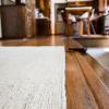 White color hemp on a wood floor. Custom shape hemp rugs cut to fit.