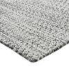 Close-up of a textured surface with a dense, irregular pattern of small dark spots on a light background, reminiscent of custom sisal rugs or other custom natural fiber rugs.