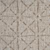 Close-up of a textured beige fabric with a herringbone pattern, displaying V-shaped woven lines reminiscent of classic area rug patterns running diagonally across the surface.