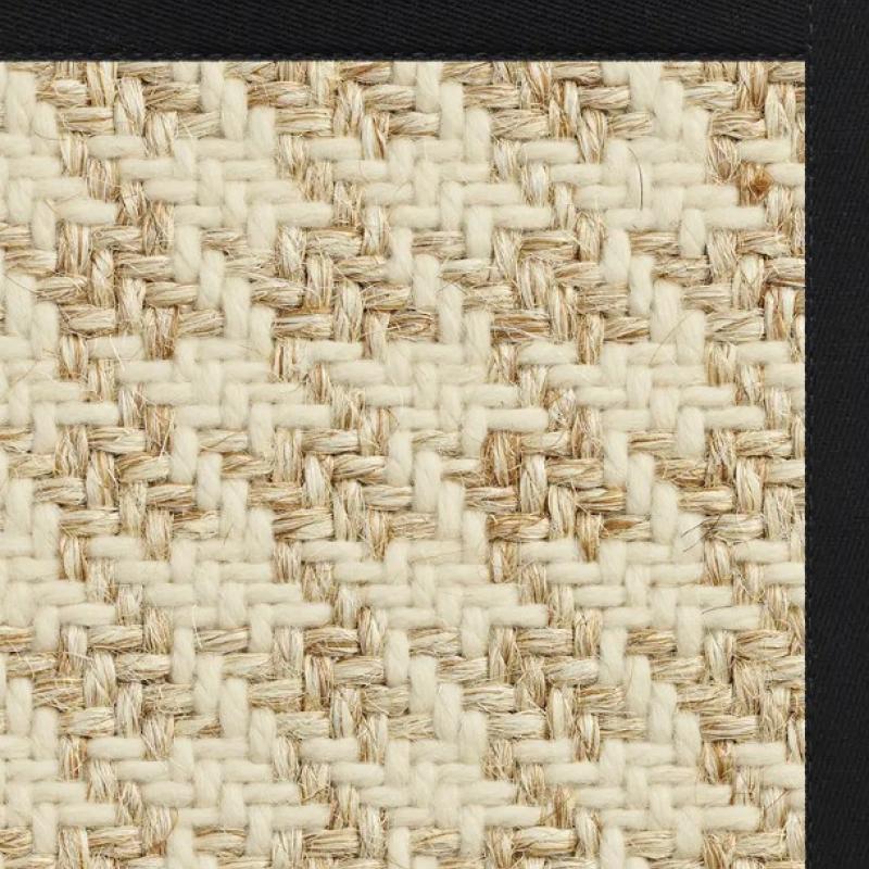 Close-up of an affordable sisal rug in beige and cream, with a zigzag pattern and black border adorning the top and right edges. The textured design showcases the interlacing fibers typical of high-quality sisal rugs on sale.
