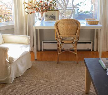 Office area with a beautiful sisal rug in prominent display.