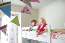 Two Little Girls Playing in a Bunk Bed