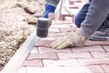 Worker Paving Patio Bricks