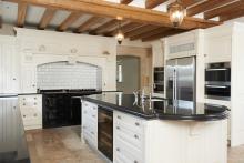 luxury fitted kitchen with a beamed ceiling