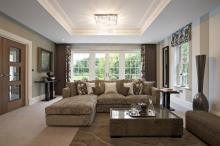 This elegant, sophisticated look pairs a decorative rug with neutral wall-to-wall carpet. Image credit: The Spruce