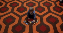 Boy Playing on a Patterned Carpet